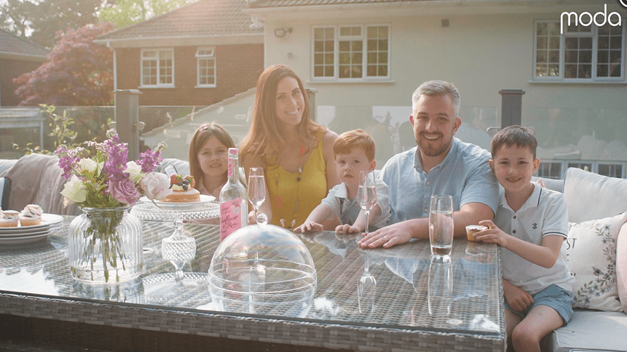 family gathered around moda dining table outdoors 